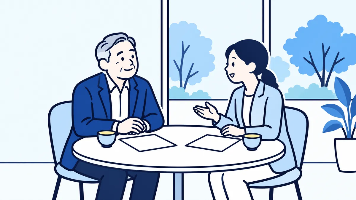公的な窓口の相談室で、社長が相談員の話を穏やかに聞いている場面
